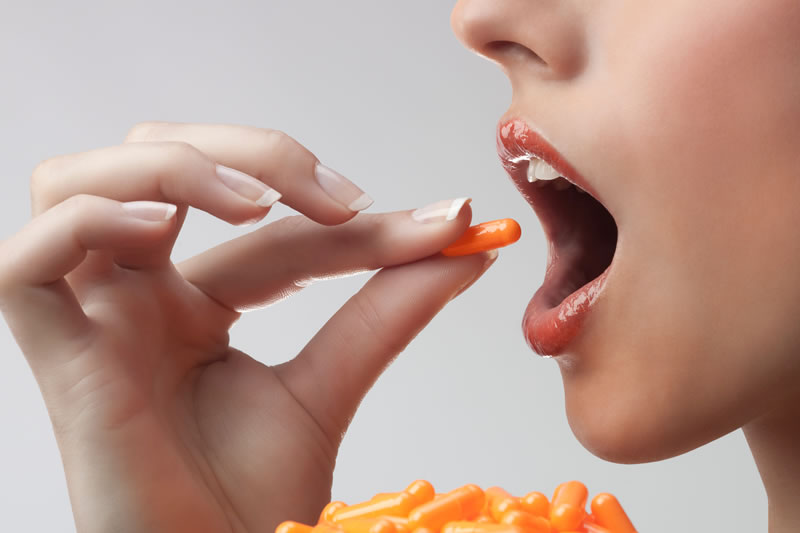 ビタミンCのサプリを飲んでいる女性