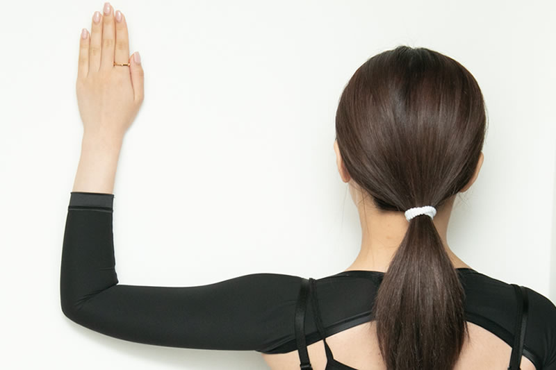 二の腕をサポーターで圧迫固定している女性